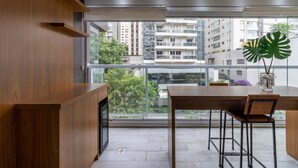 A modern kitchen with wooden cabinetry and a large window overlooking a cityscape. - Vi0301 in S o Paulo (São Paulo)