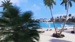 Un espace aménagé au bord de la piscine, avec des palmiers et des chaises longues.