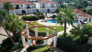 A multi-story hotel with a swimming pool, surrounded by palm trees and a well-maintained lawn. - Breakers Block 2 Unit 11 - Lifestyle Yamba (YAMBA)