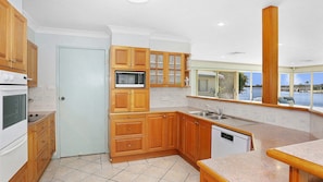 Enjoy cooking in this kitchen with a microwave, dishwasher, and large window offering a view.