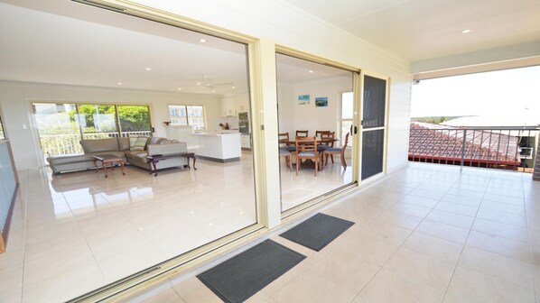 Relax in a spacious living area with a sofa set and dining table, perfect for socializing and self-catering.
