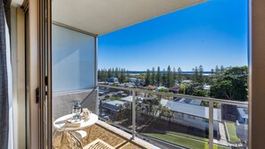 A balcony with a clear view of a residential area, including houses and trees. - Yamba Towers Unit 12 - Lifestyle Yamba (YAMBA)