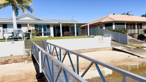 A residential property with a covered outdoor area, a gated entrance, and a small water feature. - Anchorage Waterfront Unit - Lifestyle Yamba (YAMBA)