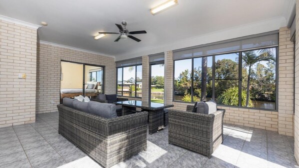 Relax in this stylish room with a comfortable sofa set, chair, and expansive views of the surrounding landscape.