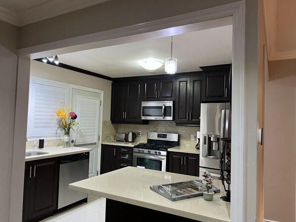 Enjoy cooking in this well-equipped kitchen with a central island and sink.