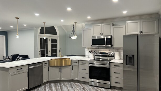 A modern kitchen with stainless steel appliances, a dishwasher, and a built-in oven. - 4 min drive to the beach (Lewes)