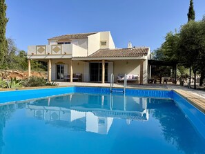 A two-story house with a swimming pool in front. - Casa Colinas Roxas by Portucasa (Olhao)