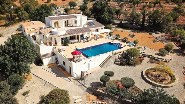 A large villa with a swimming pool, outdoor seating, and a landscaped garden. - Villa Santa Barbara by Portucasa (Faro)