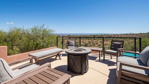An outdoor patio with a fire pit, lounge chairs, and a pool. - Stunning Views, Pool, Sauna, Steam Shower, Firepit! (Cottonwood)