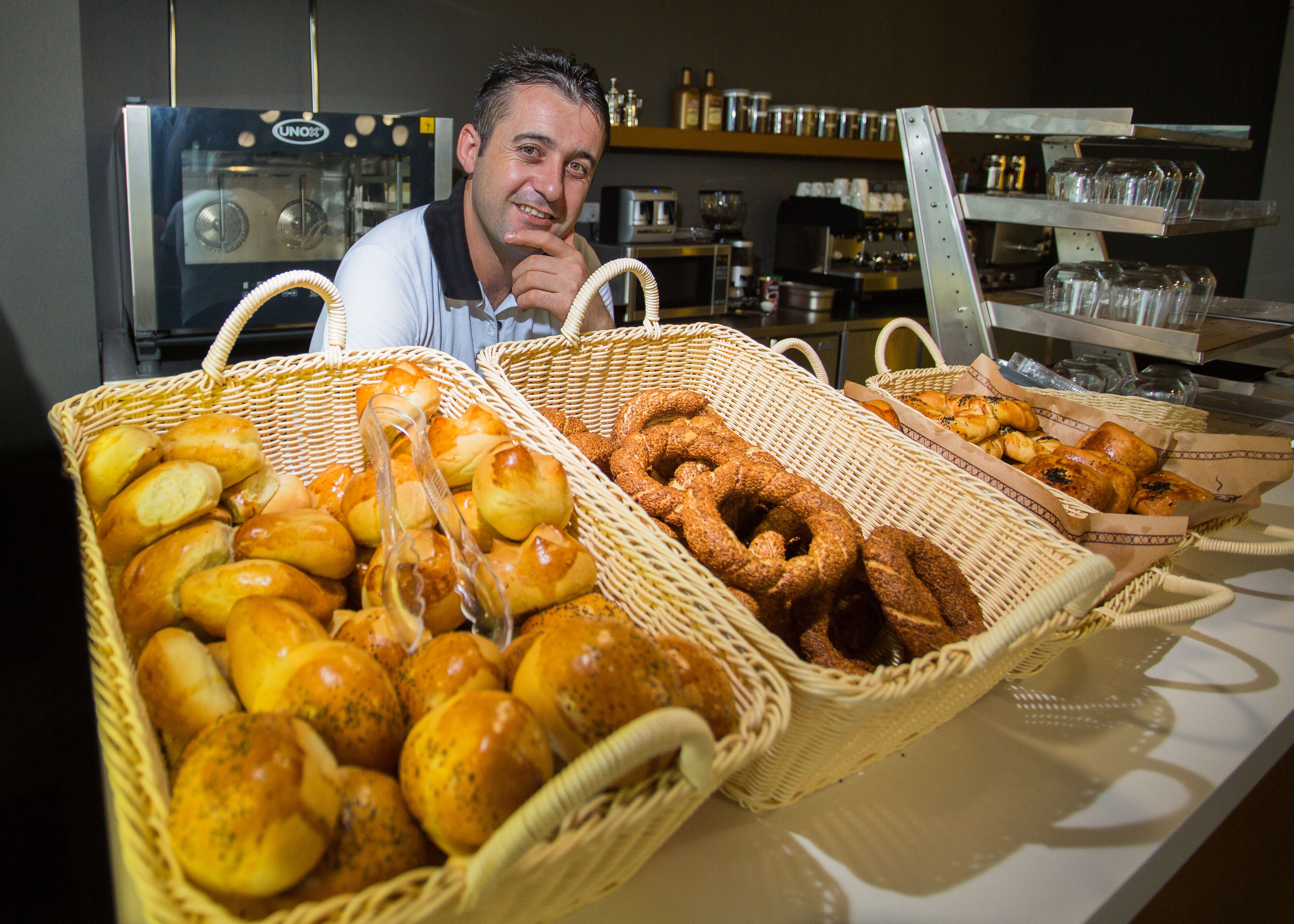 A bakery display with various baked goods in wicker baskets.