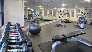A gym with various exercise equipment including dumbbells, a medicine ball, treadmills, and stationary bikes. - Christie Lodge Avon Vail for New Years (Avon)