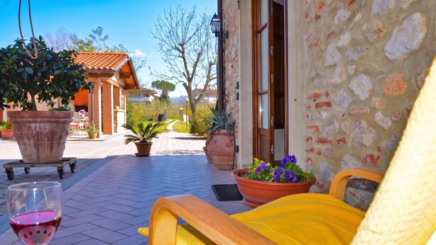 A patio with a table, chairs, and potted plants. - Casa Teresa, Camaiore, Italy (Camaiore)