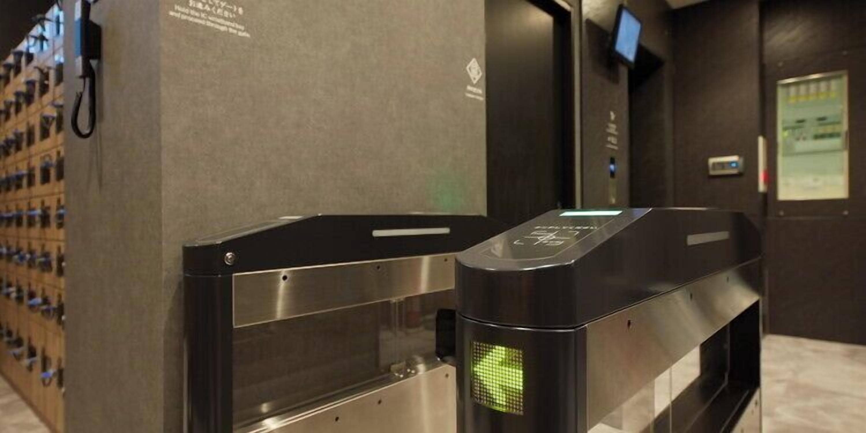 A turnstile with a green light indicating it is open.