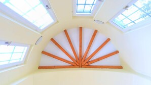 A room with a sloped ceiling and skylights. - House On The Rocks in Nisaki (Corfu)