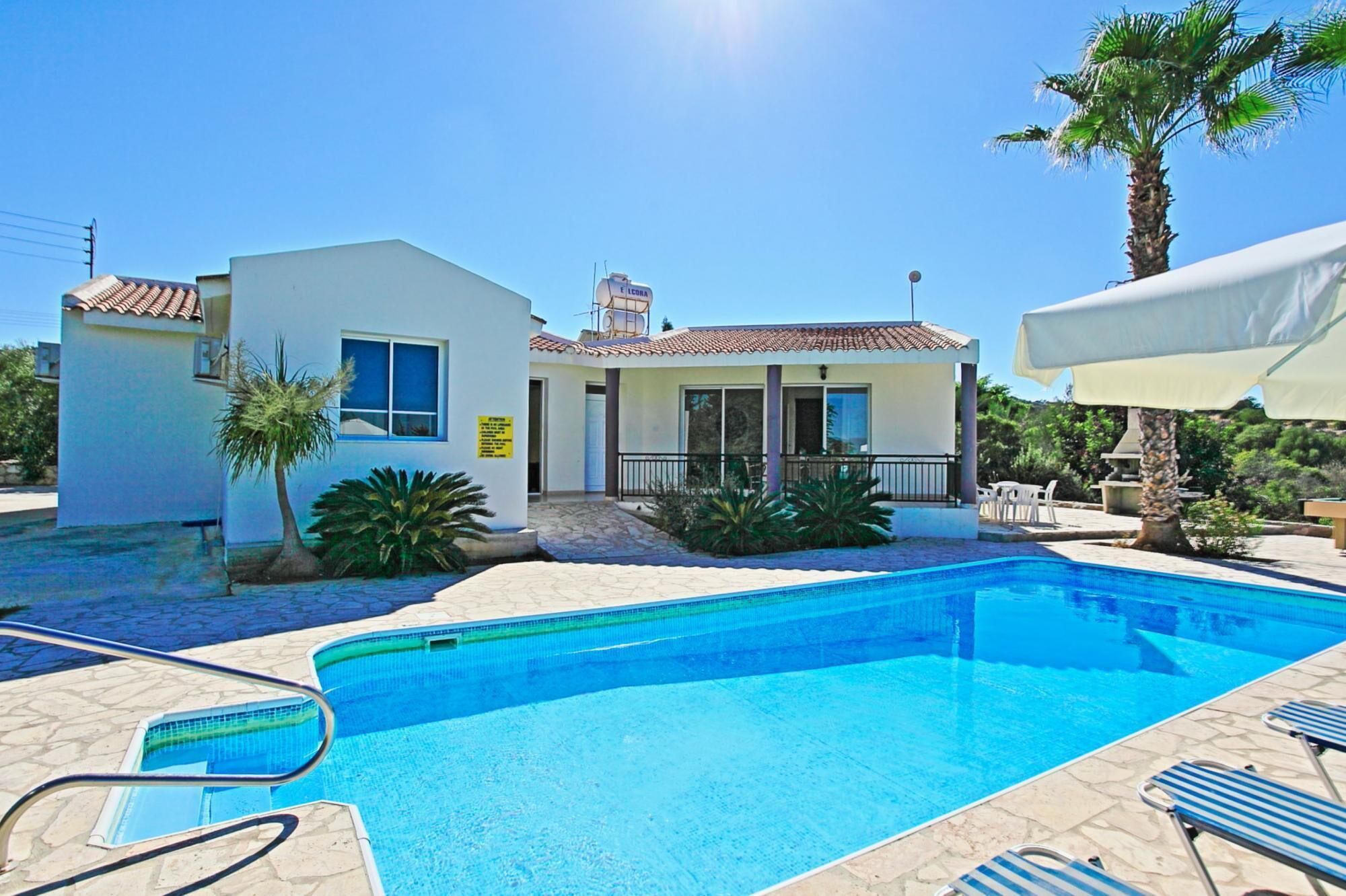 A two-story building with a swimming pool in front.