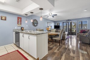 Cozy living space with a central island kitchen, dining area, and comfortable seating area.