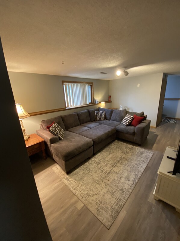 Relax in this stylish living room with a comfortable sofa, side table, and lamp.