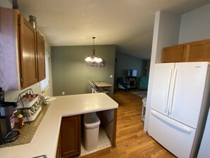 Enjoy cooking in this well-equipped kitchen with a central island, dining table, and comfortable seating area.