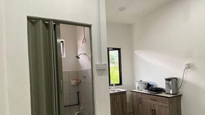 A modern kitchen with a built-in oven, a sink, and a countertop. - OYO Homes 90650 Na Homesuite (Ranau)