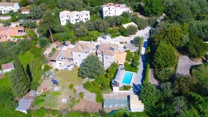Vue aérienne d’un quartier résidentiel avec de nombreuses maisons, une piscine et une serre.