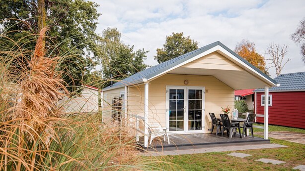 A small, single-story building with a covered patio area. - Covered Terrace Chalet at Leukermeer (Well)