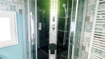 Shower, hair dryer, soap, toilet paper