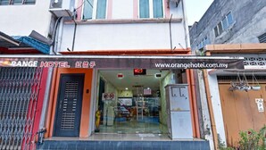 A hotel entrance with a glass door, a signboard with the hotel's name, and a website URL. - Orange Hotel Kuala Pilah (Kuala Pilah)