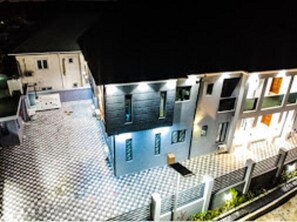 A building with a tiled ground floor and a flat roof. - Tito Empire (Lekki)