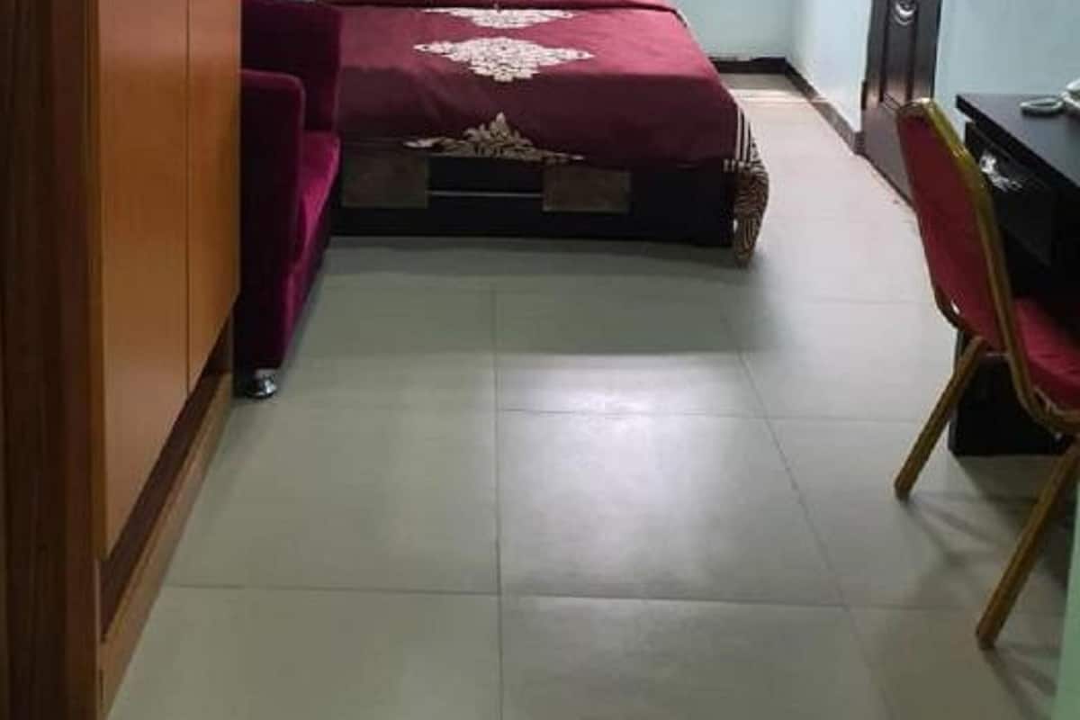 A room with a bed, a desk, and a chair.
