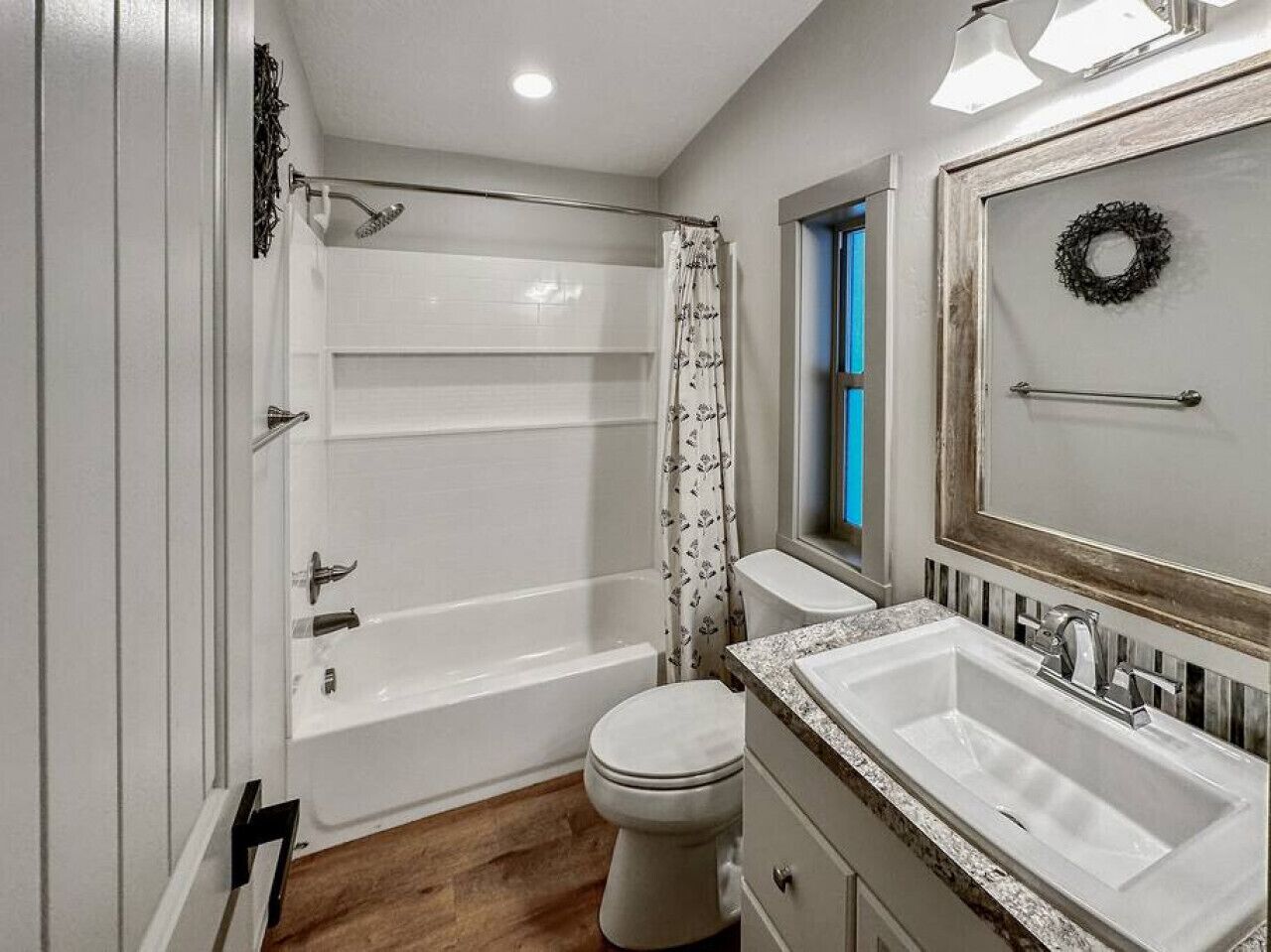 A bathroom with a bathtub, toilet, and sink.