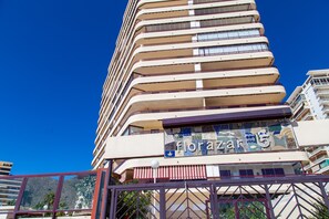 A multi-story hotel with a distinctive curved facade and a sign indicating it is the 15th floor.
