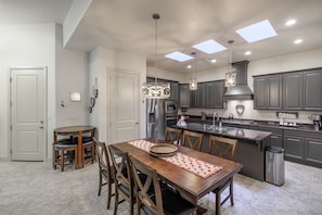 Enjoy cooking in this well-equipped kitchen with a central island, oven, and dining area.