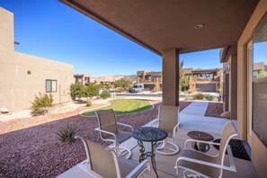 Relax on the patio with a round table and four chairs, taking in the views of the surrounding neighborhood.