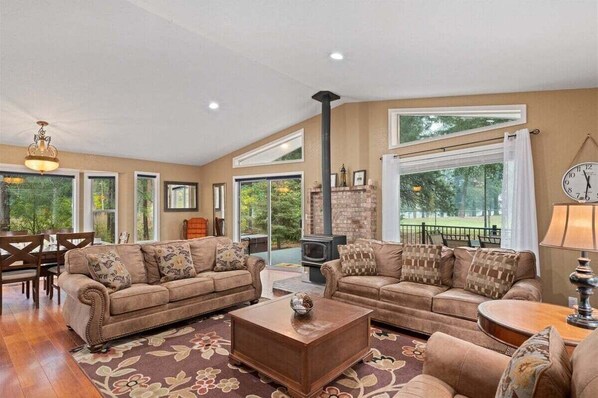 A spacious living room with two sofas, a coffee table, and a fireplace. - 3BR Retreat | Hot Tub, Pool Table & Foosball | Near Golf & Leavenworth (Leavenworth)