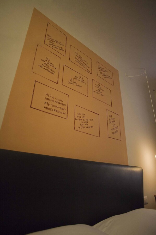 A wall with framed text boxes, each containing a year and names, likely indicating a timeline or list of notable events or people.
