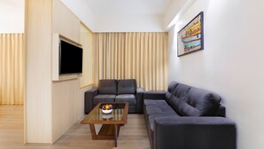 A modern living room with a sofa, a coffee table, and a flat-screen TV. - Keys Lite Sreekanya Visakhapatnam (Visakhapatnam)