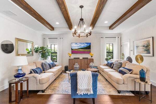 A spacious living room with two sofas, a coffee table, and a TV.