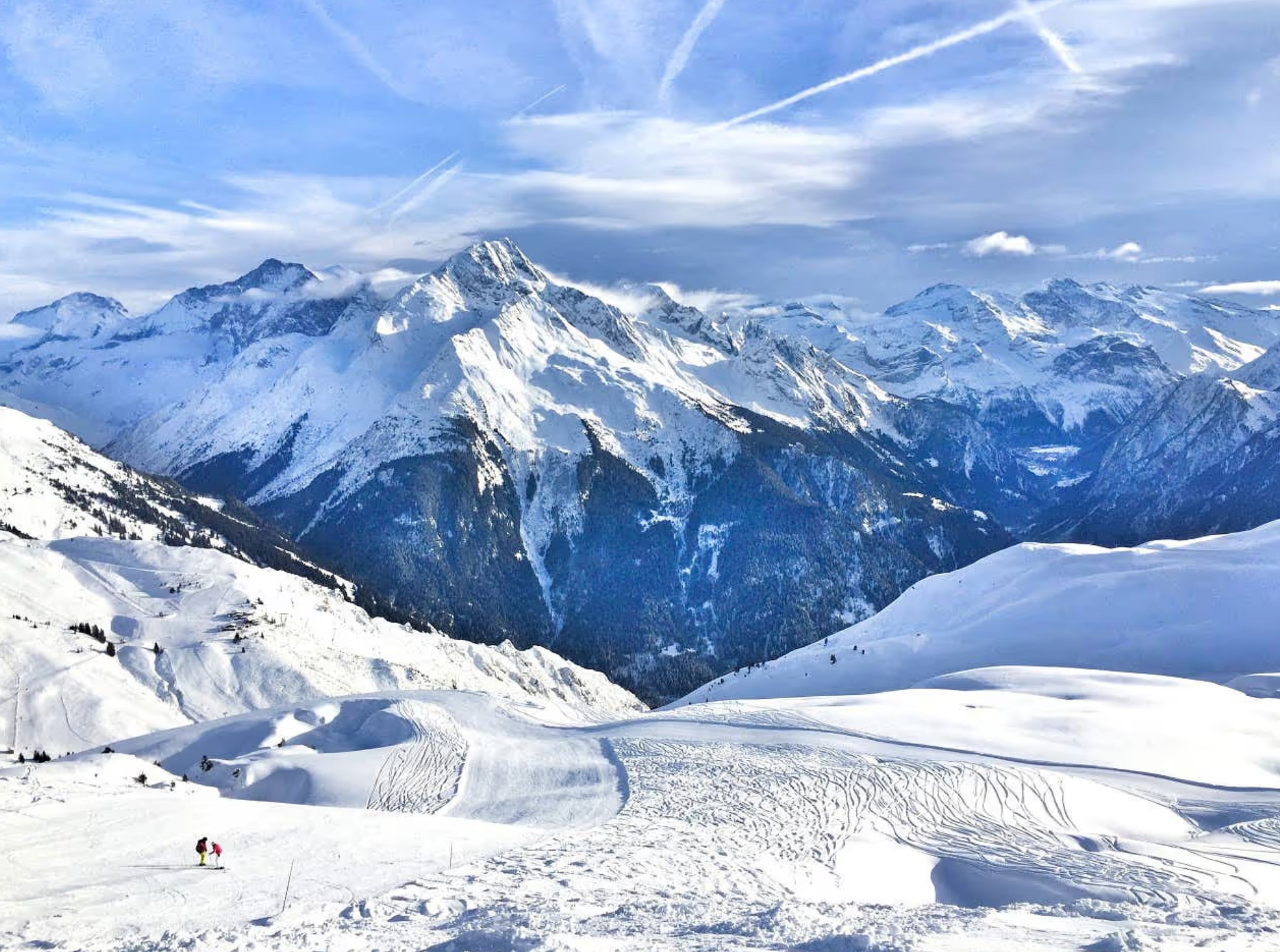 A snow-covered mountain landscape with a ski slope.