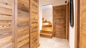 A wooden interior with a staircase leading to an upper level.