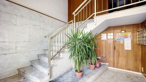 A staircase with marble steps, a wooden wall, and potted plants. - Apartment "Casa Giovanna" with Private Terrace, Private Balcony & Wi-Fi (sanremo)