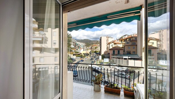 A balcony with a view of a city street, potted plants, and a tiled floor. - Apartment "Casa Giovanna" with Private Terrace, Private Balcony & Wi-Fi (sanremo)