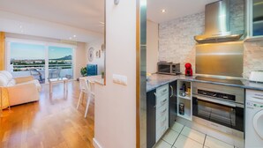 A modern kitchen with a built-in oven, microwave, and stainless steel appliances. - Apartment "Sweet Sea" in Port of Alcudia with Shared Pool, Shared Terraces & Wi-Fi (Puerto de Alcudia)