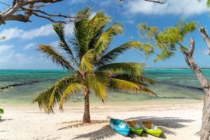On the beach, white sand, sun loungers, beach towels