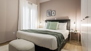 A bedroom with a bed, bedside table, and a nightstand. - Gorgeous 1BR Apartment in Kolonaki (Athens)