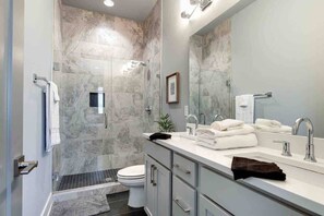 Shower, hair dryer, towels, shampoo