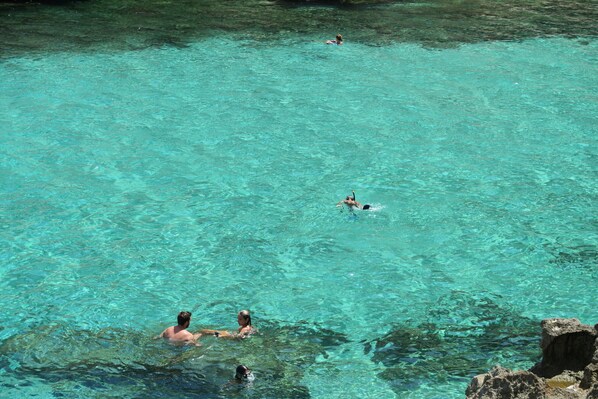 A clear turquoise pool surrounded by rocky terrain. - Townhouse Calvario at Calvari (Pollensa / Pollença)