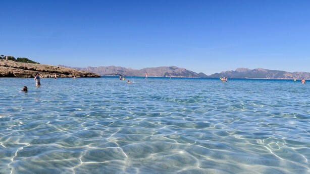 A clear blue sea with people swimming and standing in the water. - Majorca Villa with pool in Majorca - Villa Font (Mancor de la Vall)