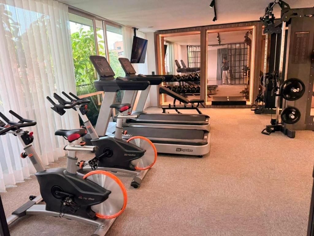 A gym with treadmills, stationary bikes, and weight machines.
