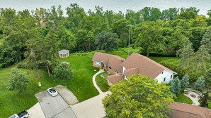 A residential property with a house, a covered patio, and a view of the sea. - Coastal Suite #1 - Seacliff Beach Suites (Leamington)