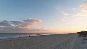 A beach with a clear sky and a few clouds. - 3 Bedroom Lower Duplex w Ocean Views and Game Room (Wrightsville Beach)